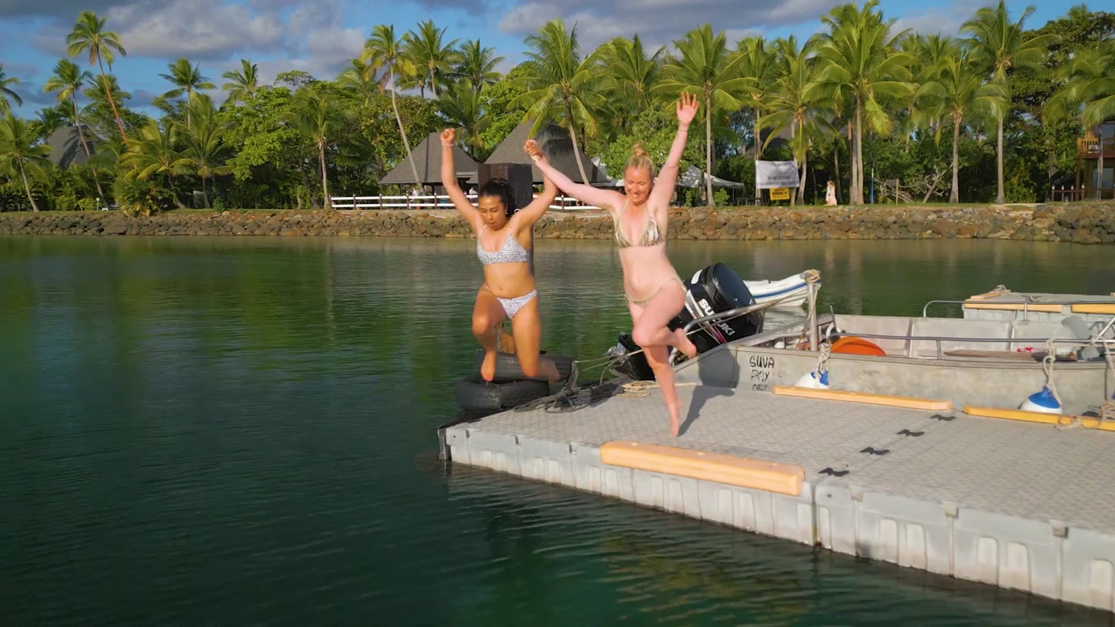 Women jumping off the jetty, Fiji 2022